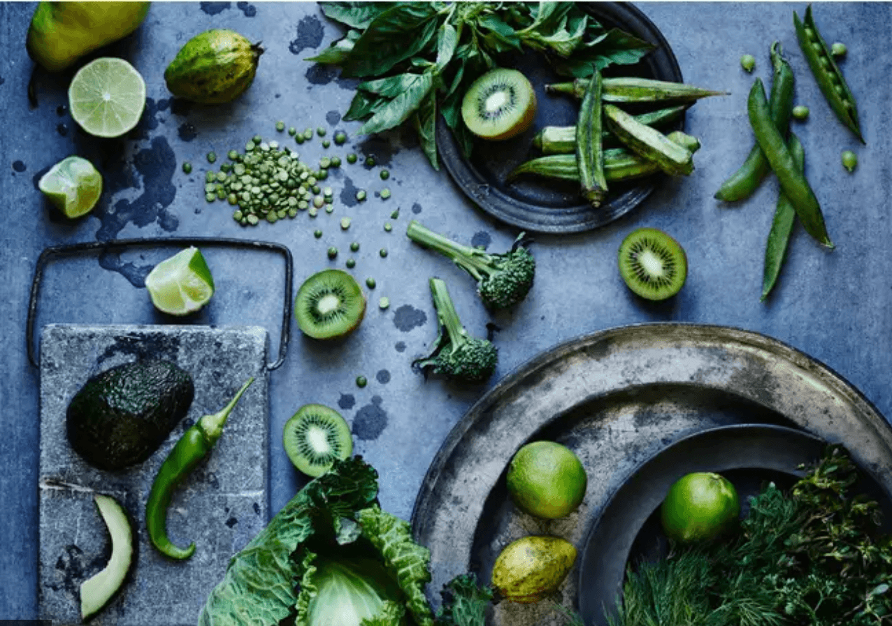 Photo of green veg on dark kitchen surface